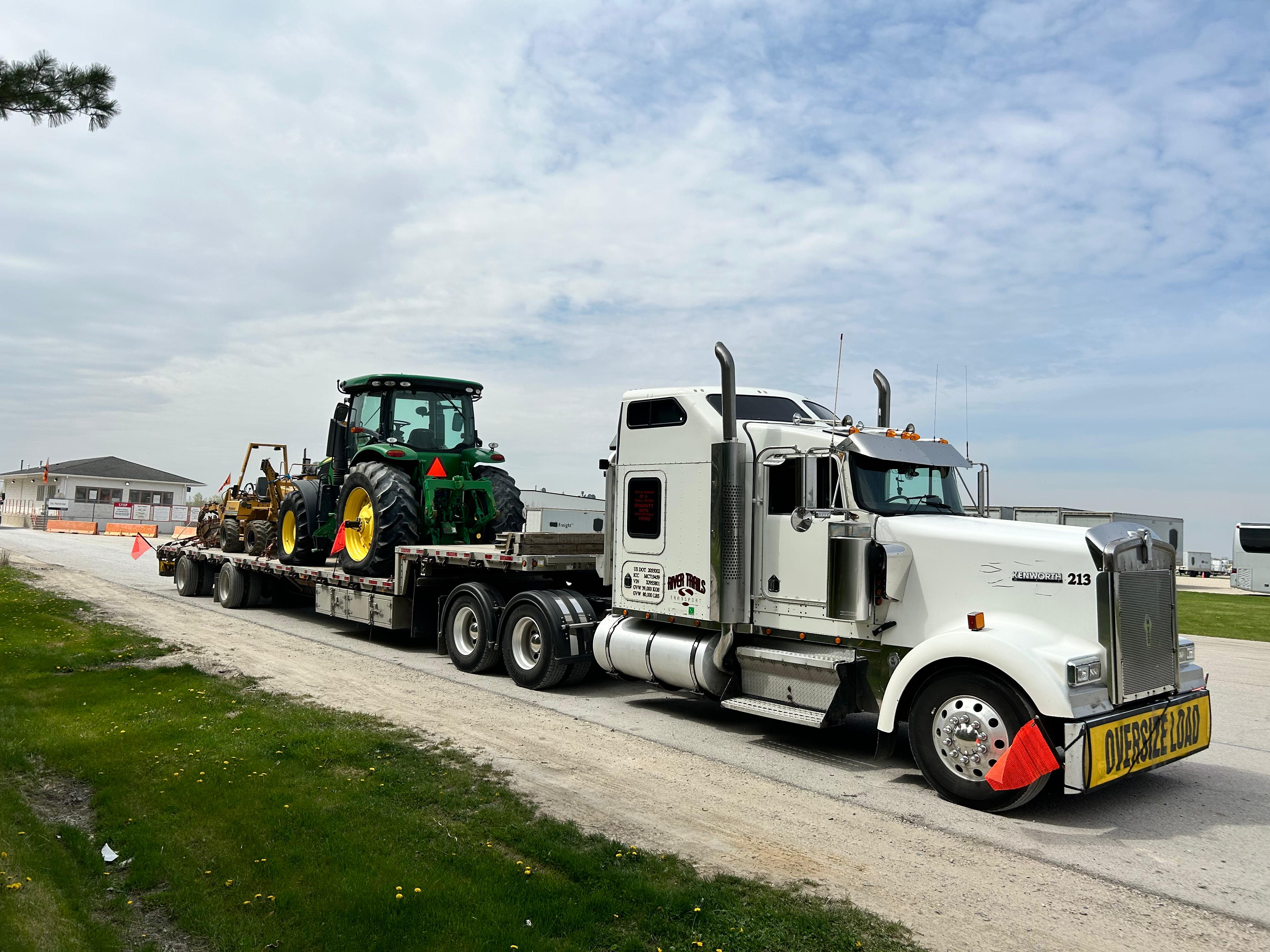John Deere tractor loaded on a River Trails Transport tandem step deck
